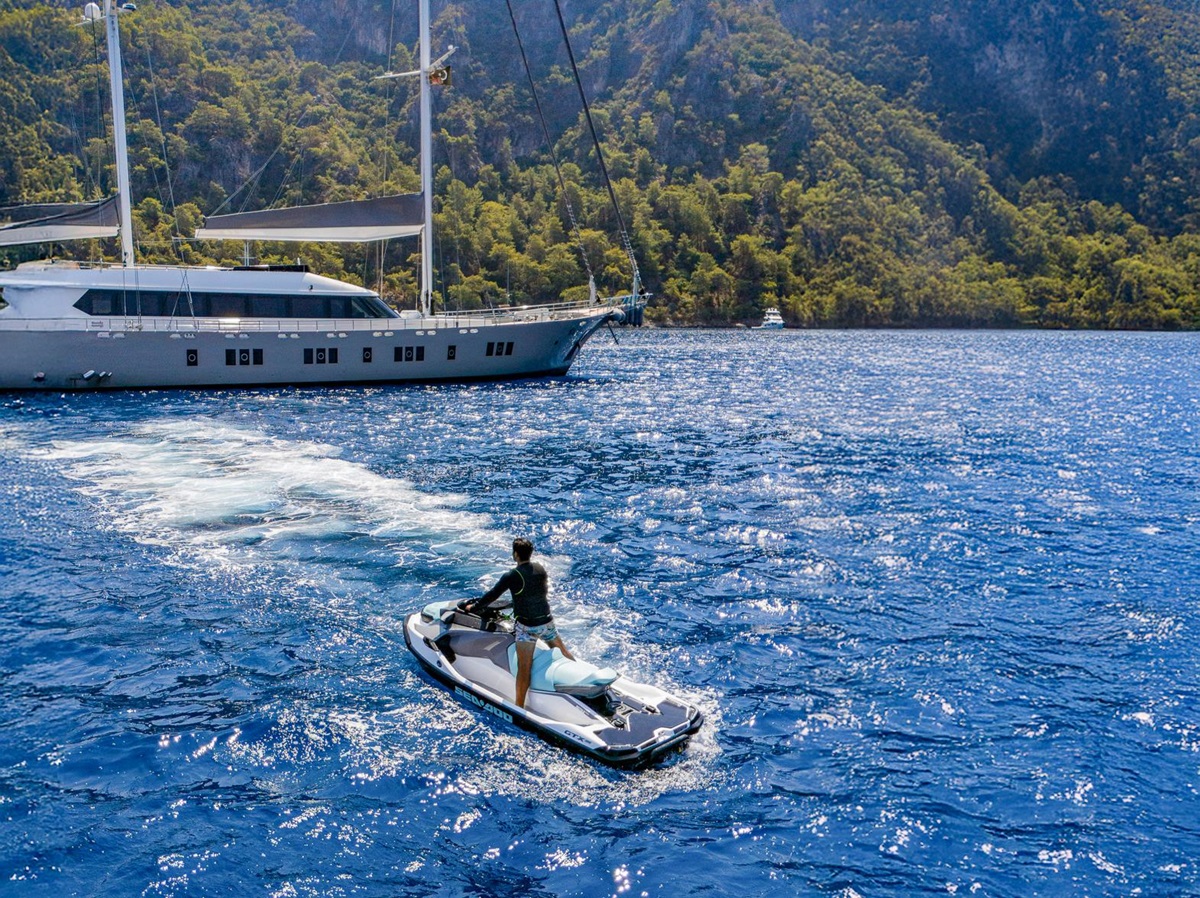 A man jetskiing from the De Love luxury motor sailer in Turkey