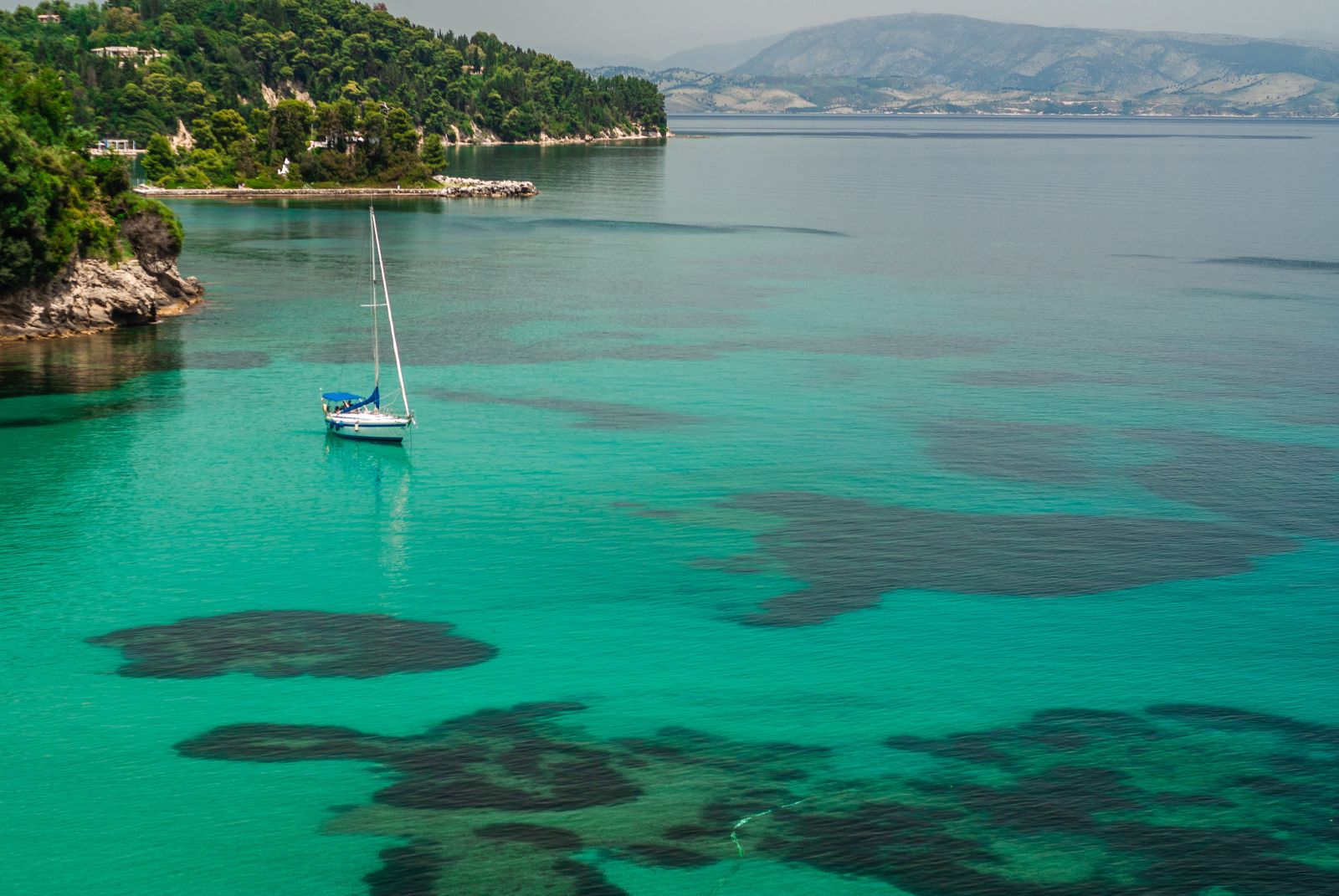 Aerial view of a yacht and turquoise sea in Greece