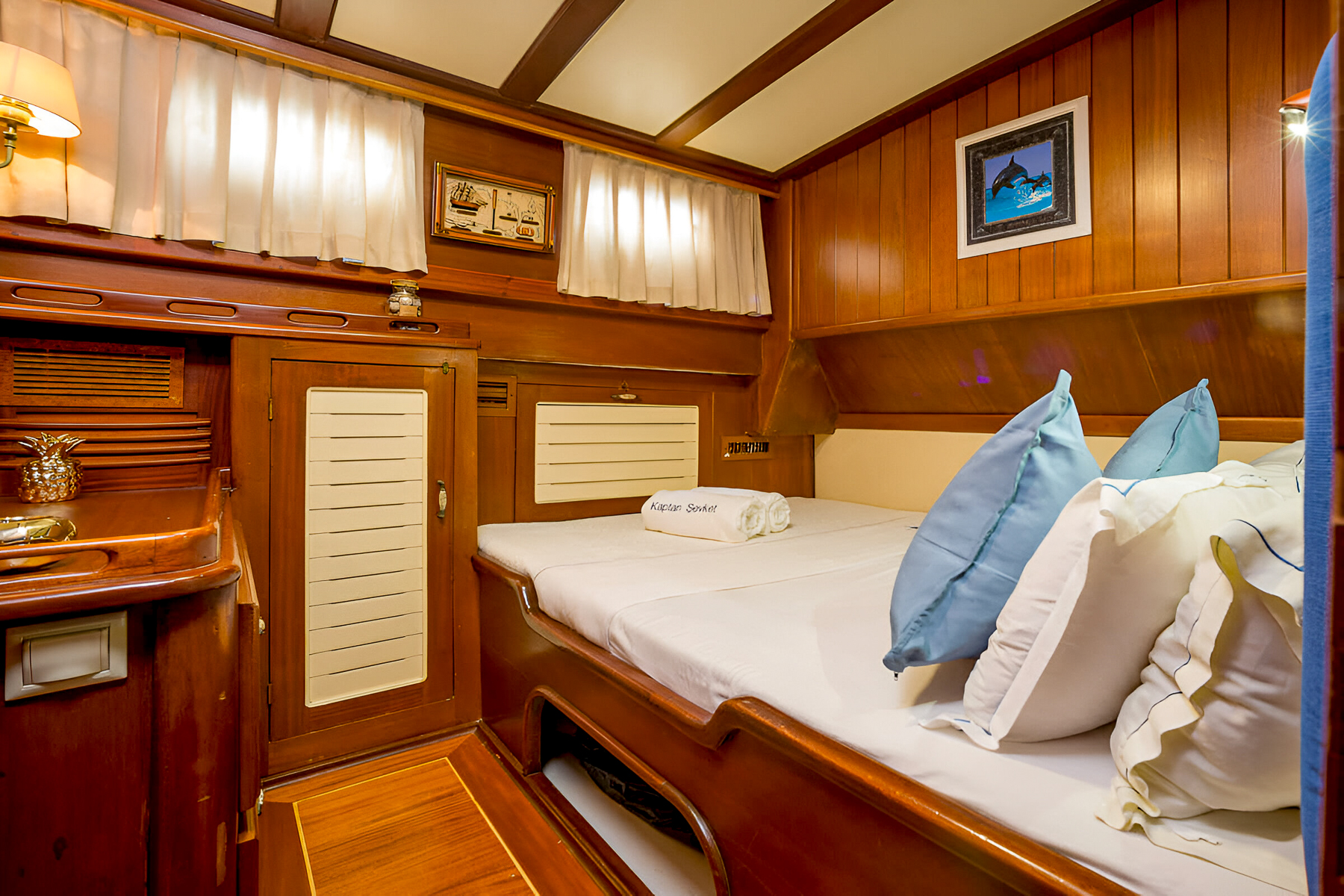Guest cabin with blue cushions onboard the Kaptan Sevket luxury gulet in Montenegro