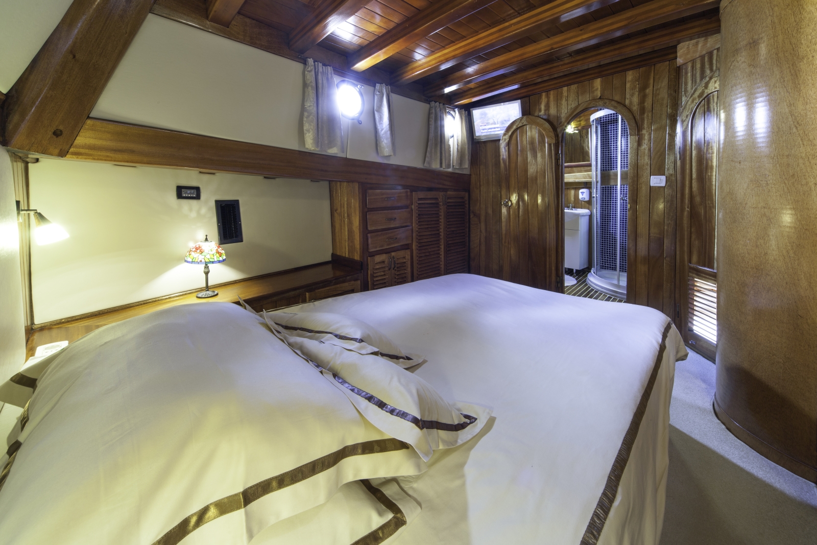 nterior of master cabin with ensuite bathroom onboard the luxury gulet Libra