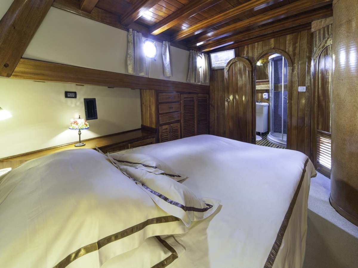 nterior of master cabin with ensuite bathroom onboard the luxury gulet Libra