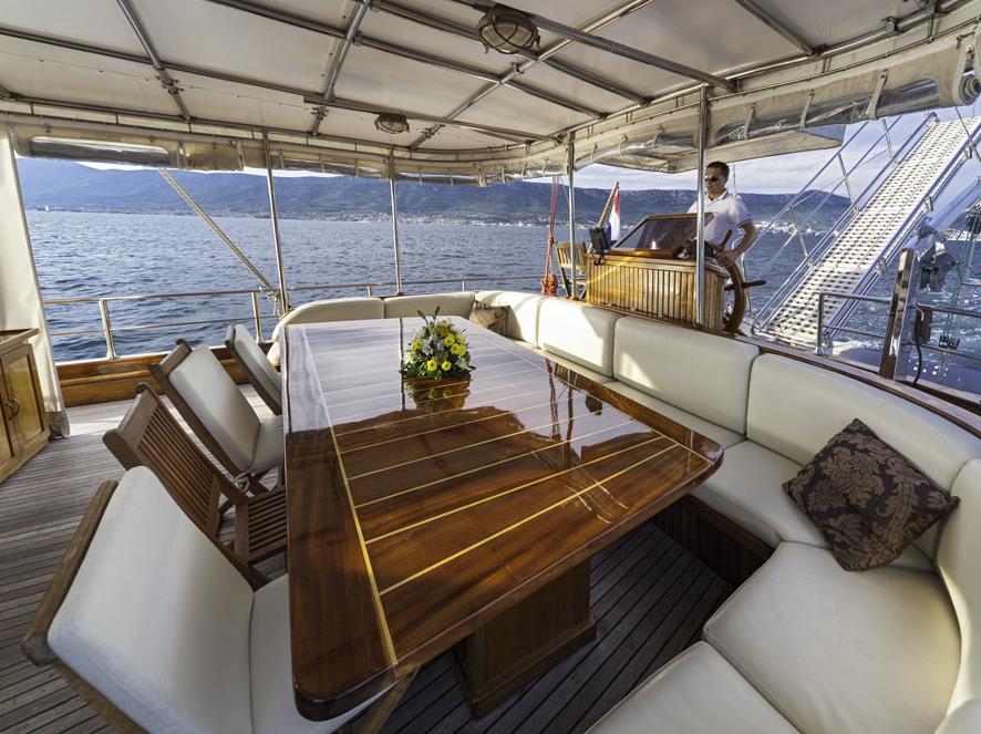 Outdoor dining area and captain aboard the Libra gulet in Croatia