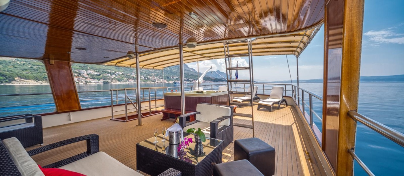 Seating area on the deck of luxury gulet Luna with loungers and chairs