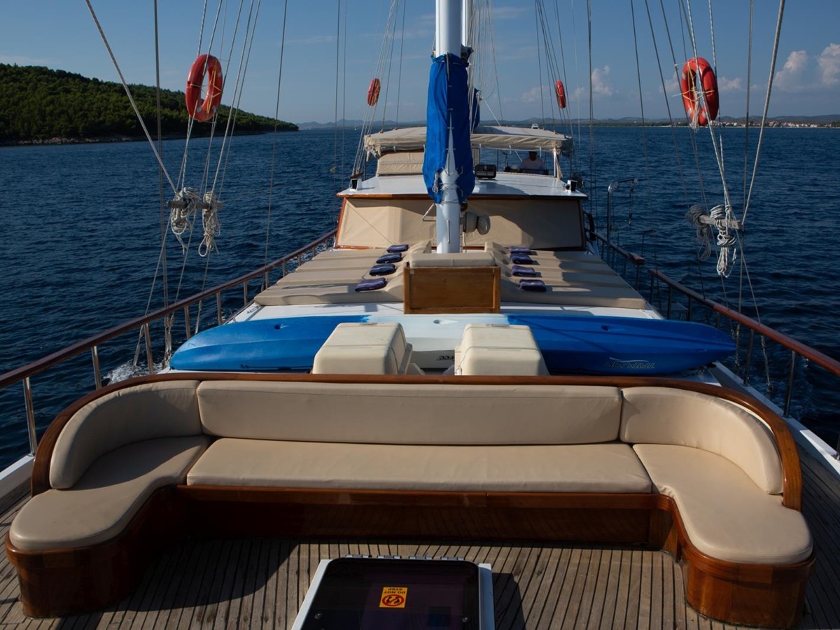 View over the deck of luxury gulet Malena with seating area and loungers