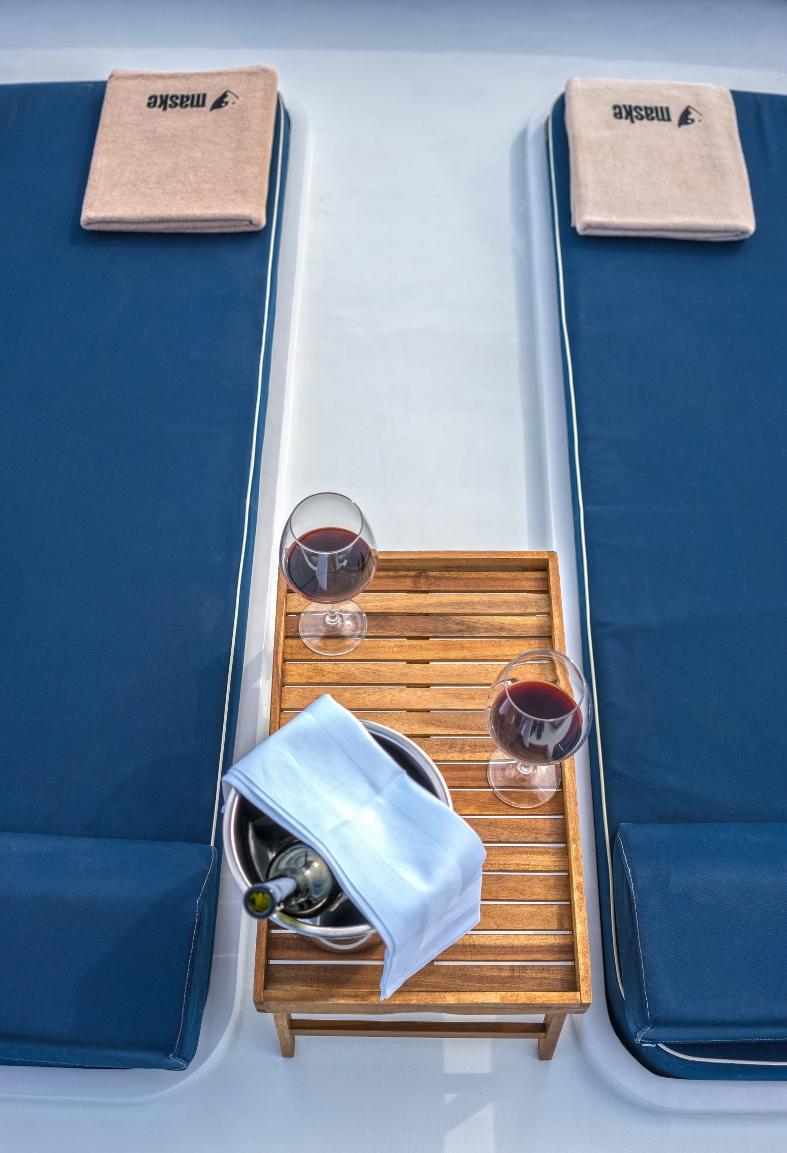 Two loungers, a chilled bottle of wine and two wine glasses on the luxury gulet Maske