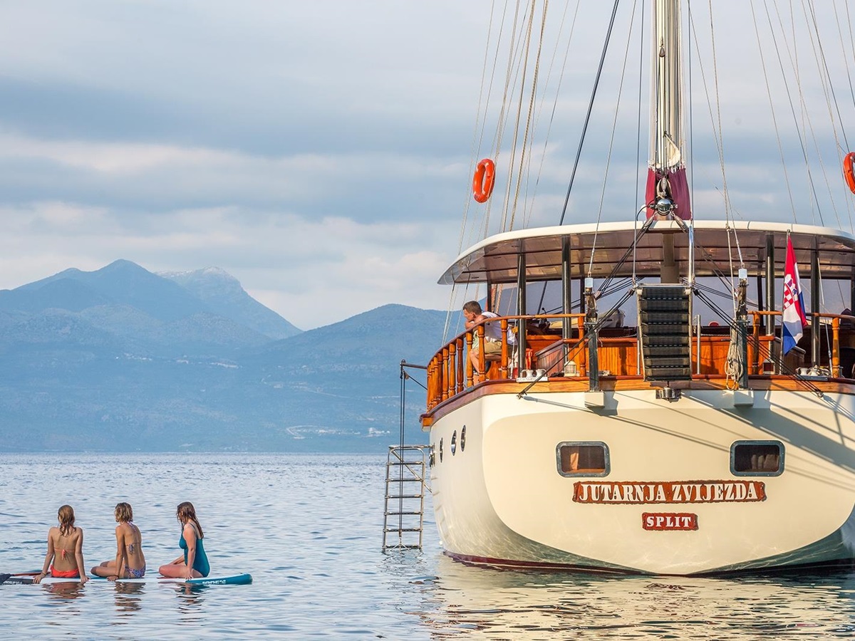 Rear view of Morning Star with people in the water in Croatia