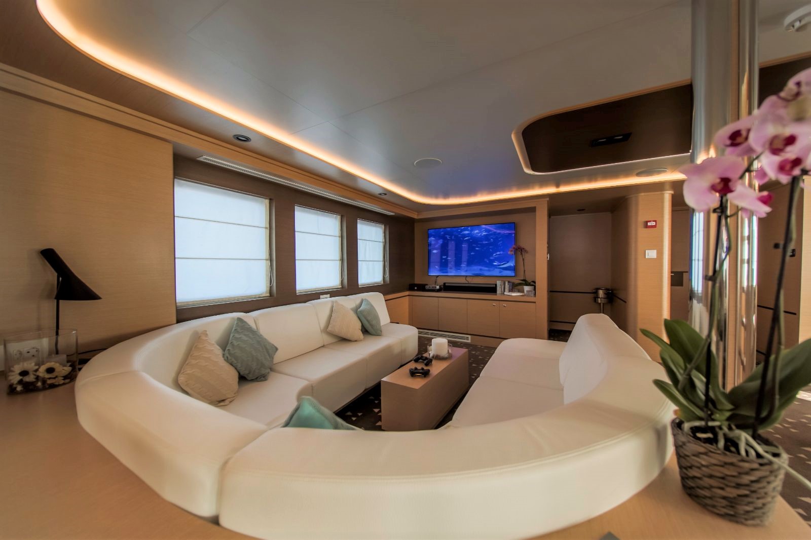Indoor sofa seating area with television onboard the Omnia gulet in Croatia