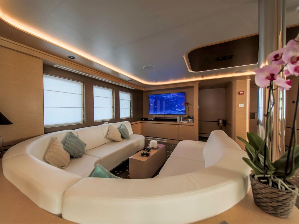 Indoor sofa seating area with television onboard the Omnia gulet in Croatia