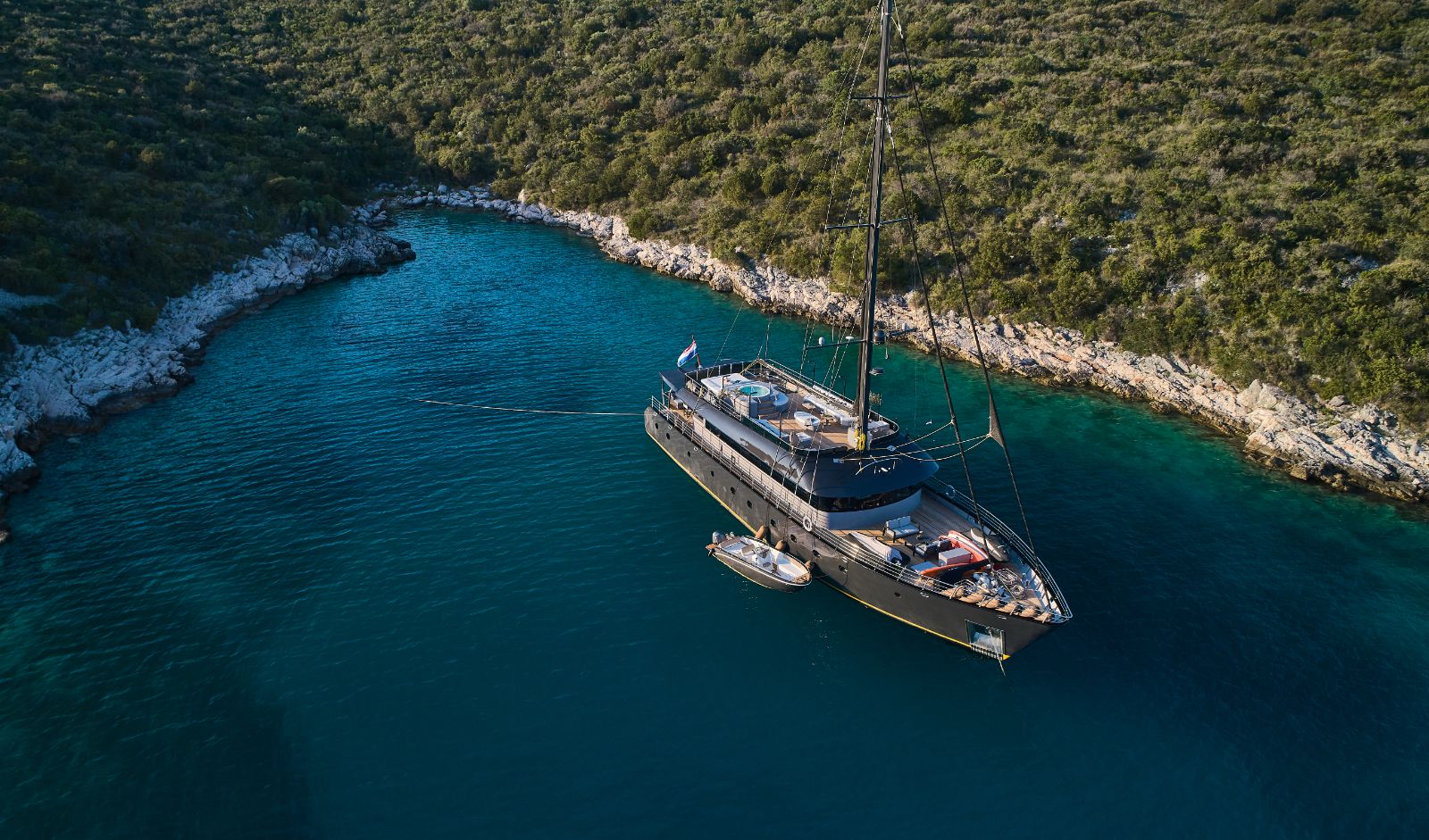 Exterior view of Rara Avis gulet and zodiac at bay in Croatia