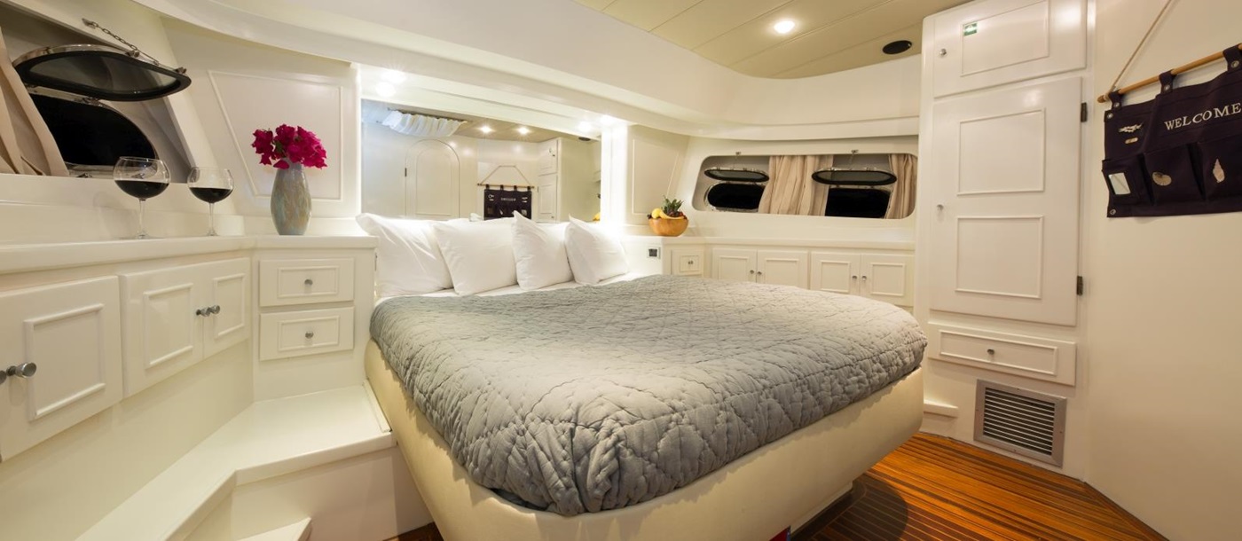 Master cabin onboard the Serenity 70, a Turkish gulet, with plenty of storage, windows and a modern design