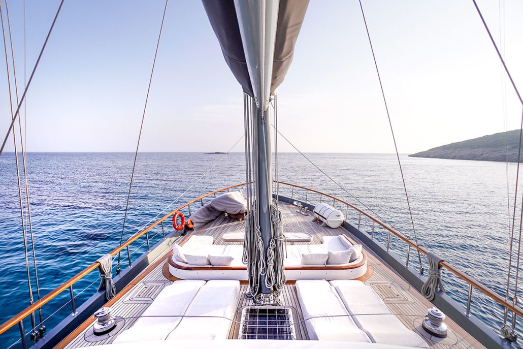 View over deck deck of the luxury gulet Virtuoso and the shores of Greece
