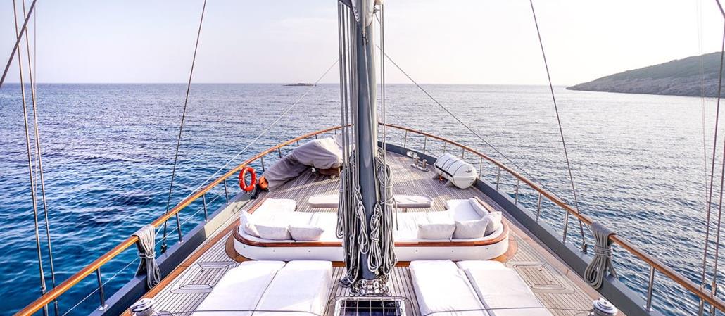 View over deck deck of the luxury gulet Virtuoso and the shores of Greece