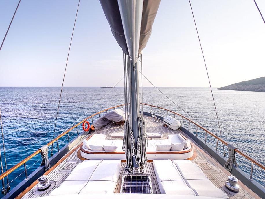 View over deck deck of the luxury gulet Virtuoso and the shores of Greece