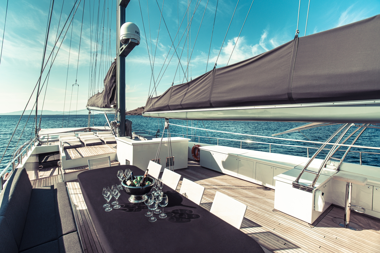 View over the deck of the luxury gulet Virtuoso with dining space and sun loungers