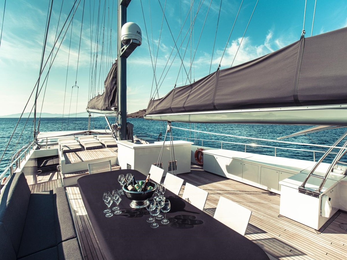 View over the deck of the luxury gulet Virtuoso with dining space and sun loungers