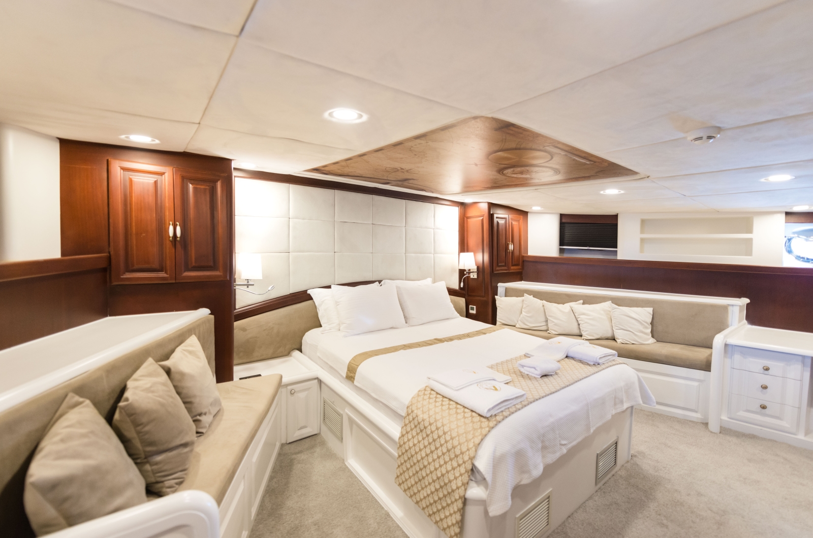 Spacious double cabin with windows, seating and plenty of storage onboard the luxury gulet Virtuoso
