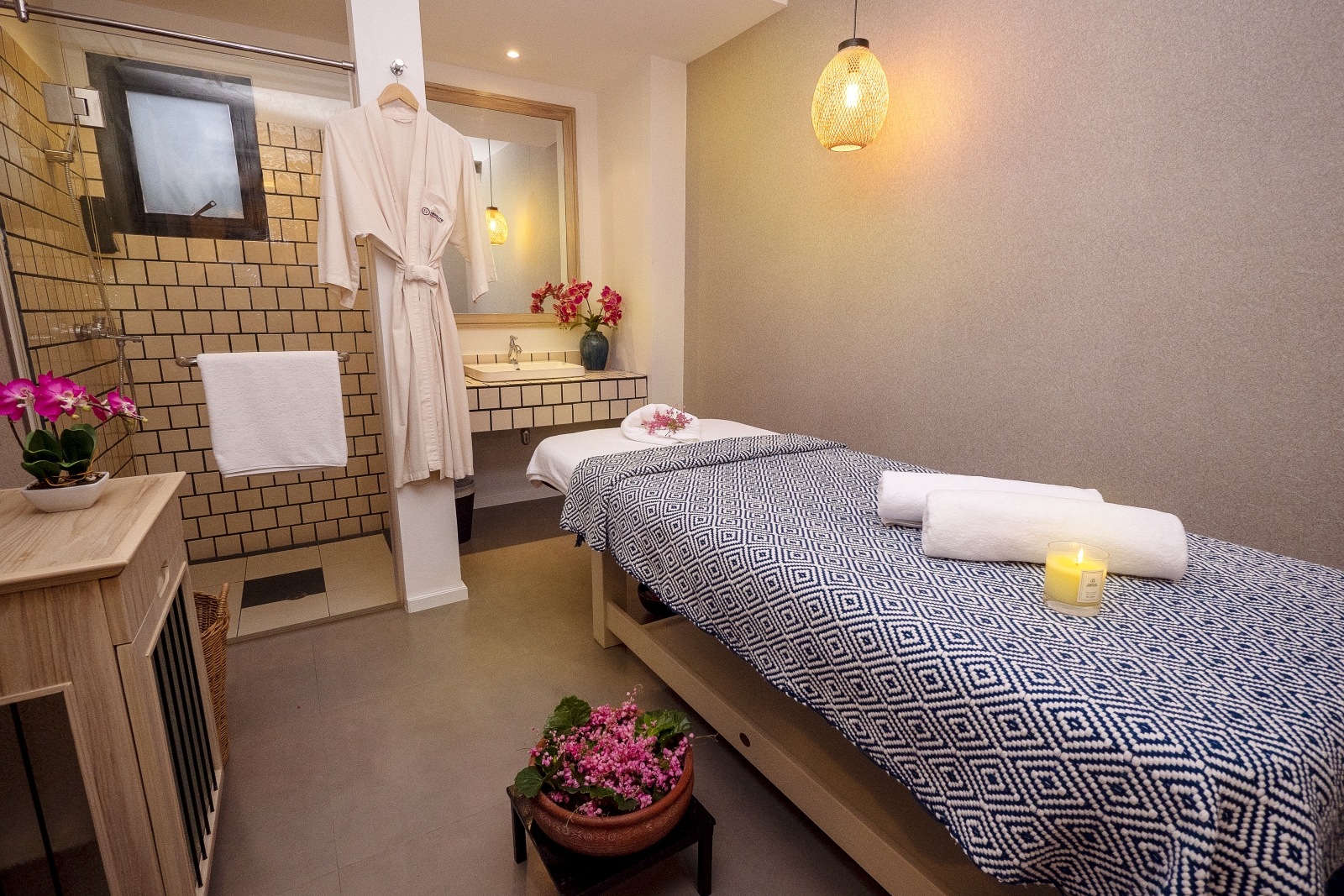 Single spa treatment room with shower and plenty of flowers at luxury Zen resort Absolute Sanctuary in Thailand