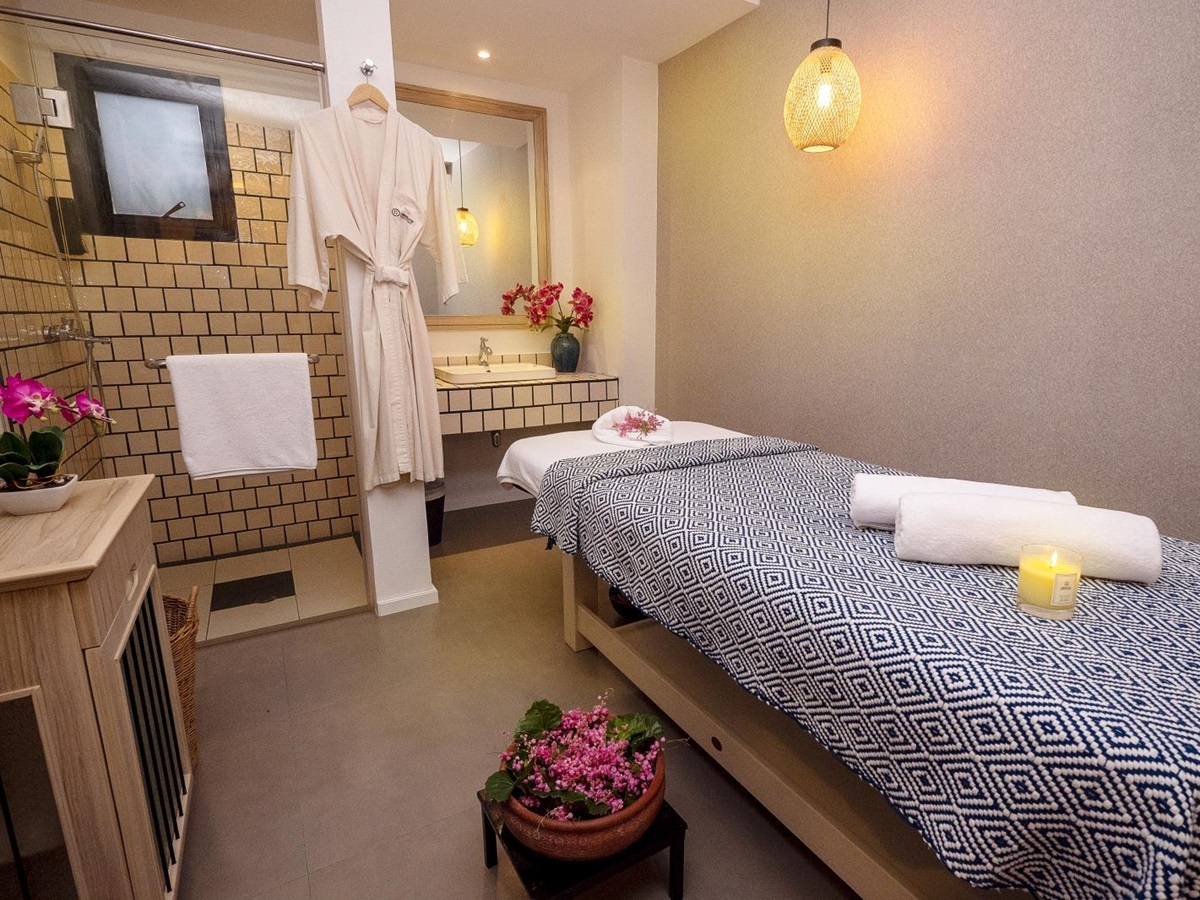 Single spa treatment room with shower and plenty of flowers at luxury Zen resort Absolute Sanctuary in Thailand