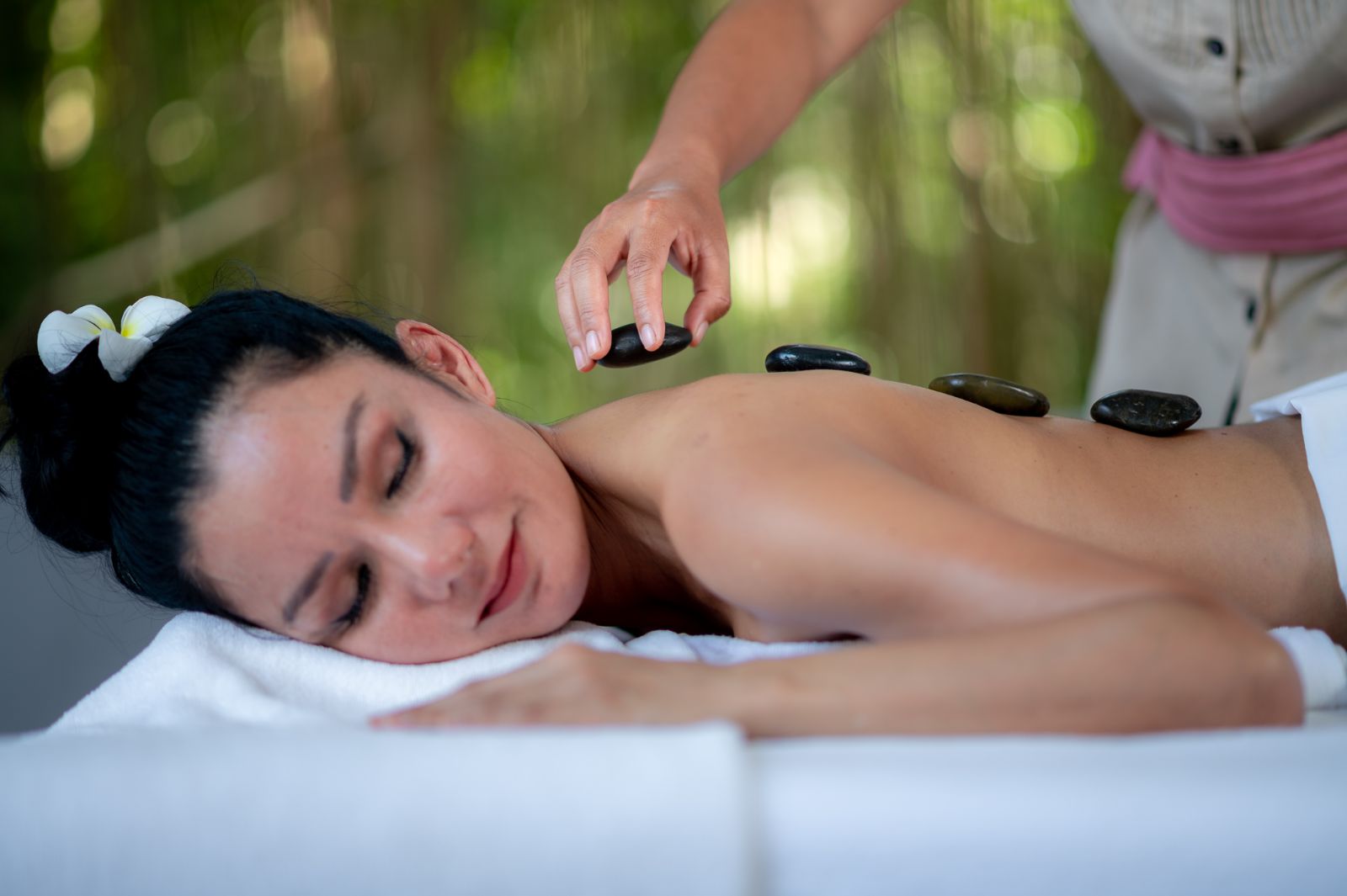 Someone getting a hot stone massage at luxury zen resort Absolute Sanctuary 