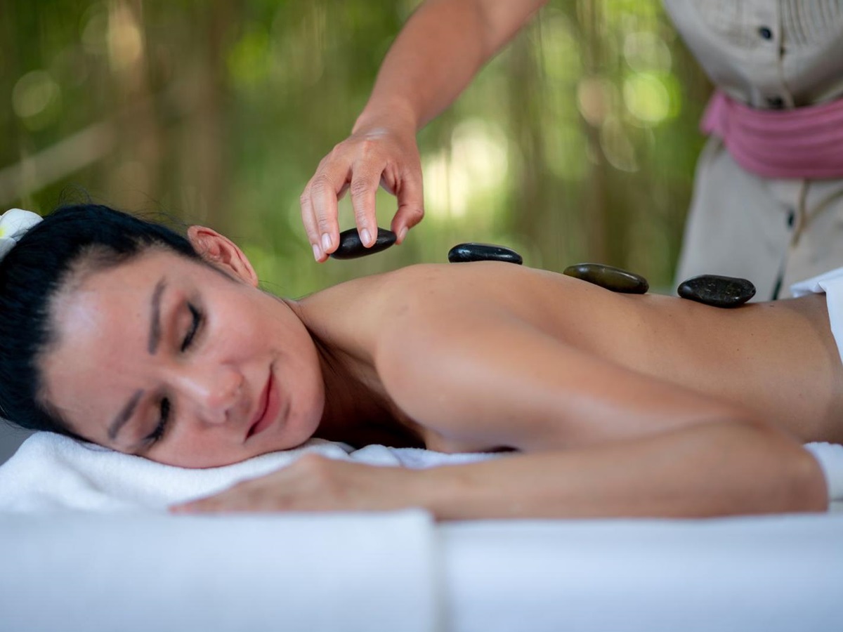 Someone getting a hot stone massage at luxury zen resort Absolute Sanctuary