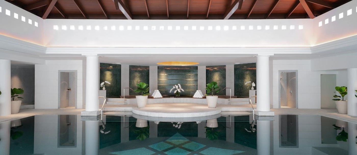 Indoor pool with seating area at Luxury resort Chiva Som